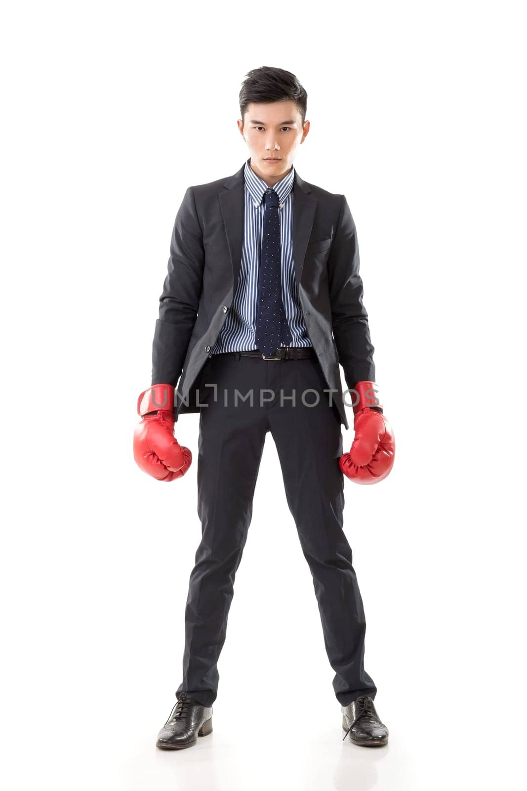Asian businessman with boxing gloves, full length portrait isolated on white background. Concept about fight, struggle, against etc.