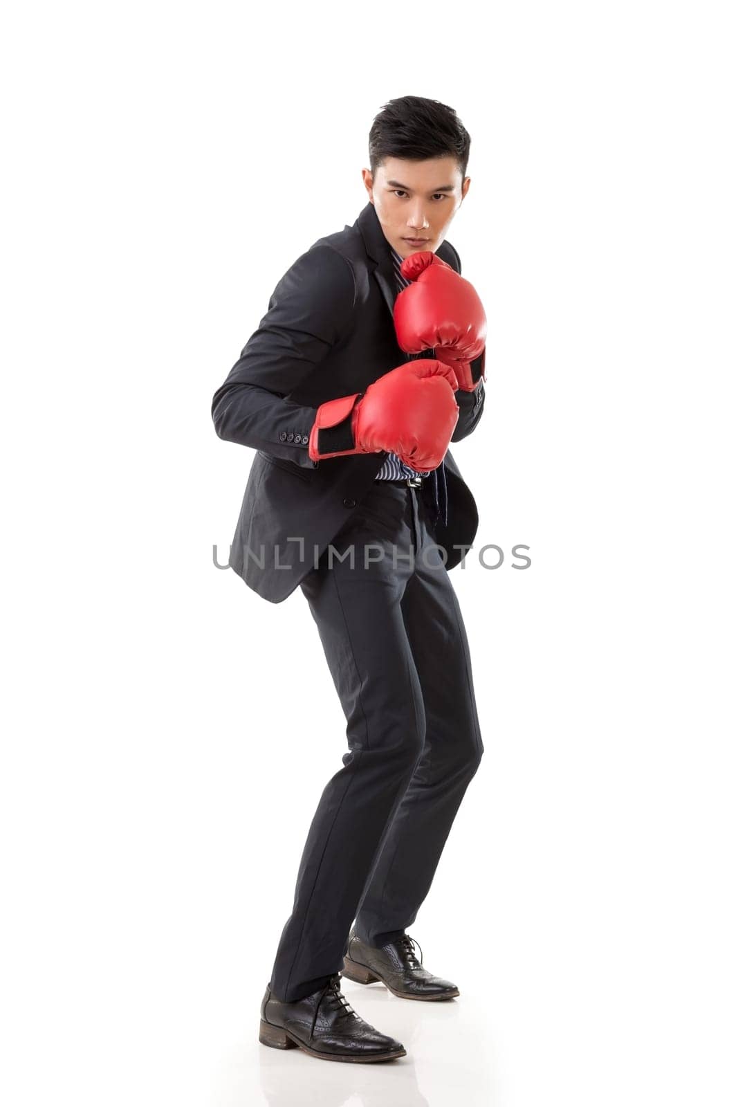 Asian businessman with boxing gloves, full length portrait isolated on white background. Concept about fight, struggle, against etc.