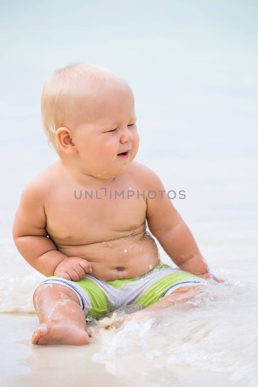 Cute baby on the tropical beach