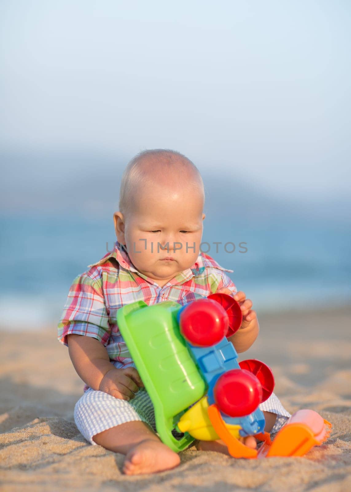 Cute baby is playing toy car