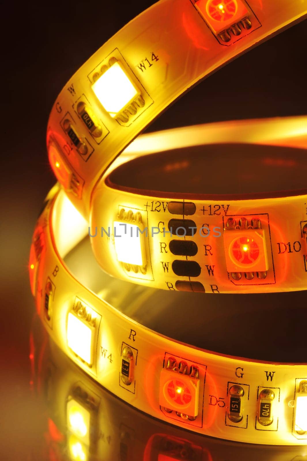 Macrodetail of an RGB LED strip combined with warm white LEDs in colored light