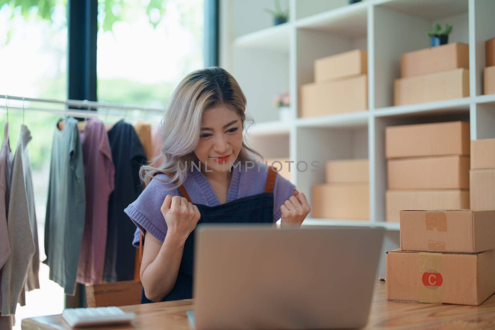 Portrait Of Asian Female Owner Of Fashion Store Clothing Store successful happy smile at small business, sme or ecommerce concepts by Manastrong