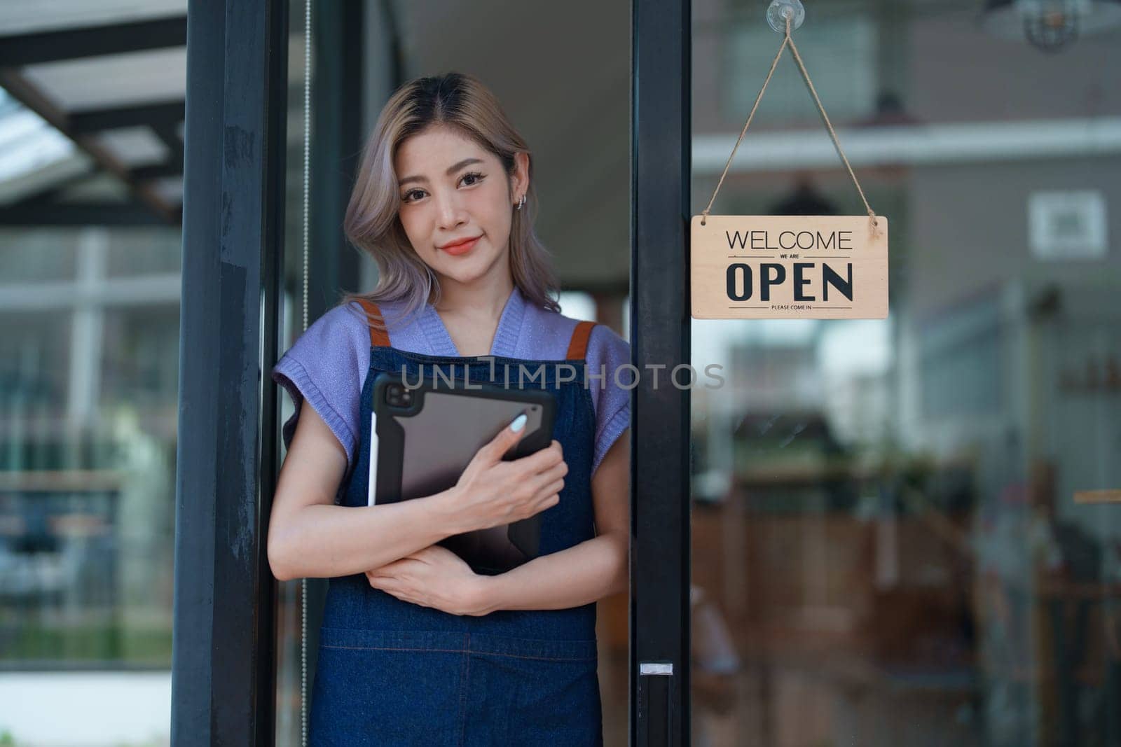 Startup successful small business owner sme beauty girl stand with tablet in coffee shop restaurant, asian tan woman barista cafe owner, entrepreneur seller business concept by Manastrong