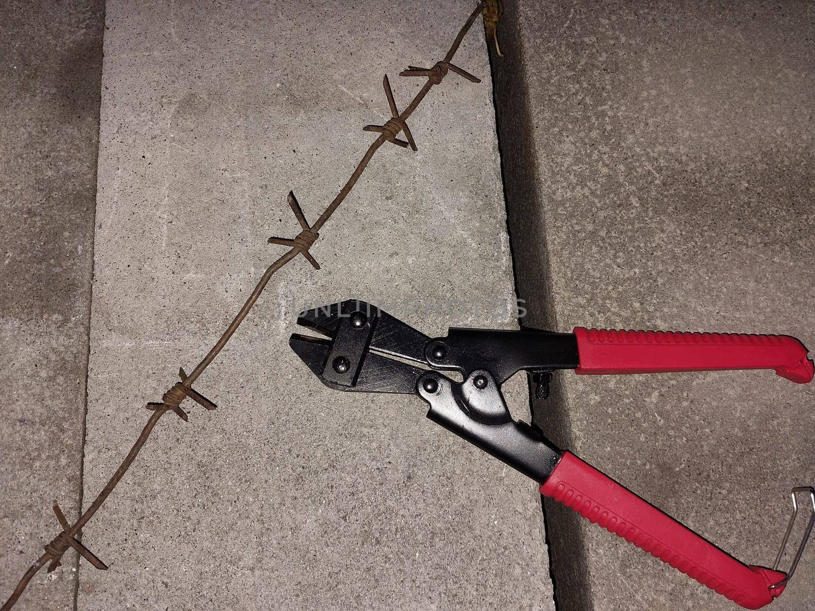 Cutting through a the barbed wire fence
