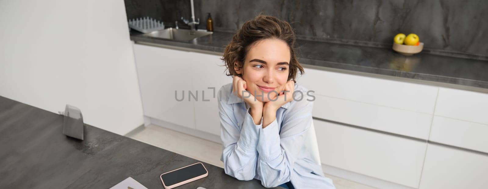 Portrait of young woman watching video on laptop computer, working from home, studying online, listening webinar course.