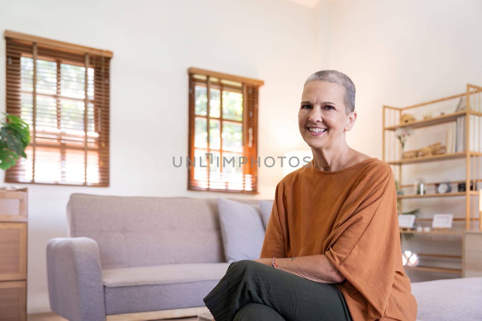 Portrait of happy smile senior woman caucasian while sitting on the sofa at home by nateemee