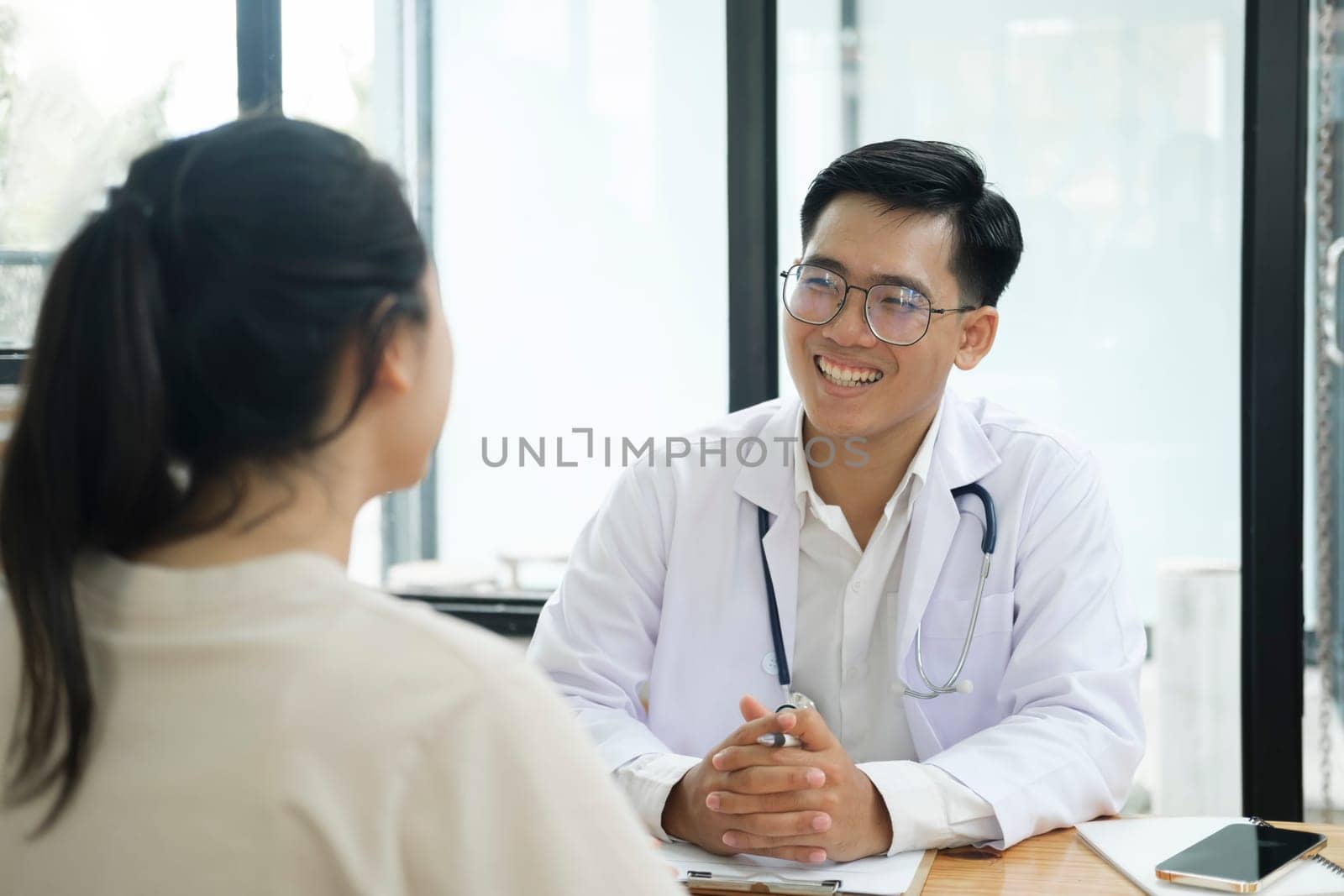 Doctor talking to a patient at medical clinic.. by ijeab