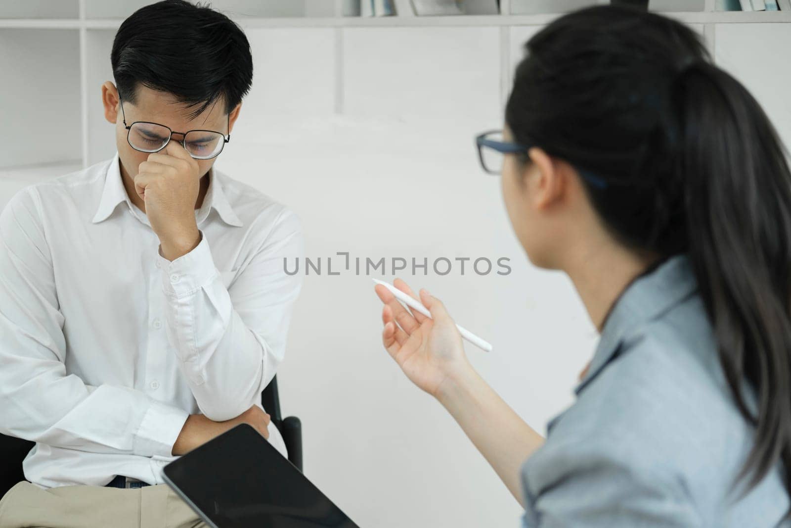 Depressed man patient talking on appointment with experienced psychologist psychology male therapist specialist doctor psychiatry mental help support session clinic consultation depression disorder.