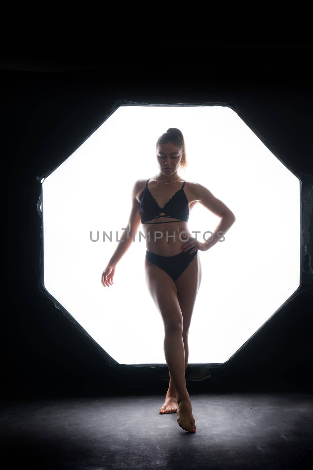 Silhouette of a beautiful young woman wearing underwear in backlight by Zelenin