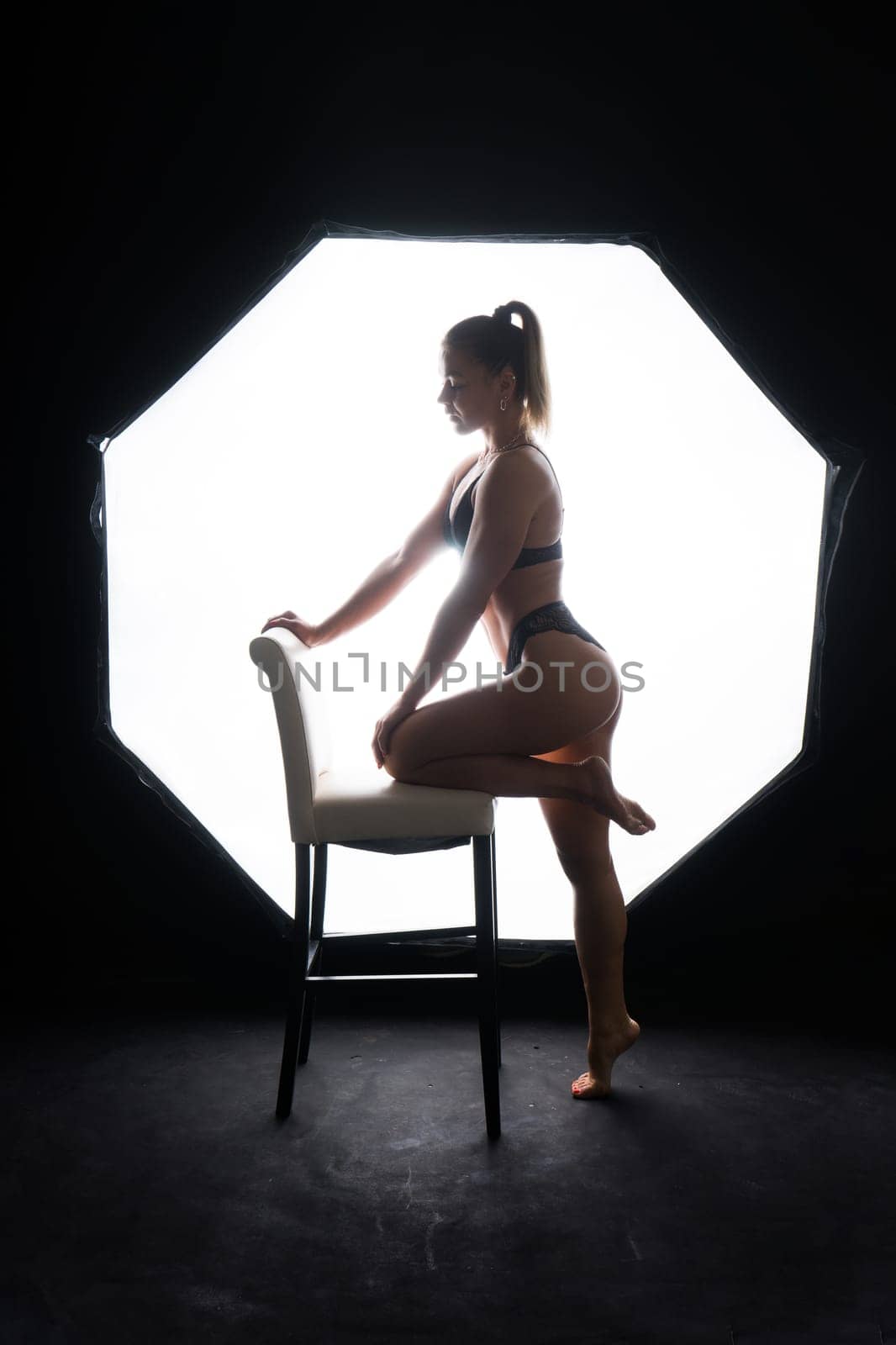 Silhouette of a beautiful young woman wearing underwear in backlight by Zelenin