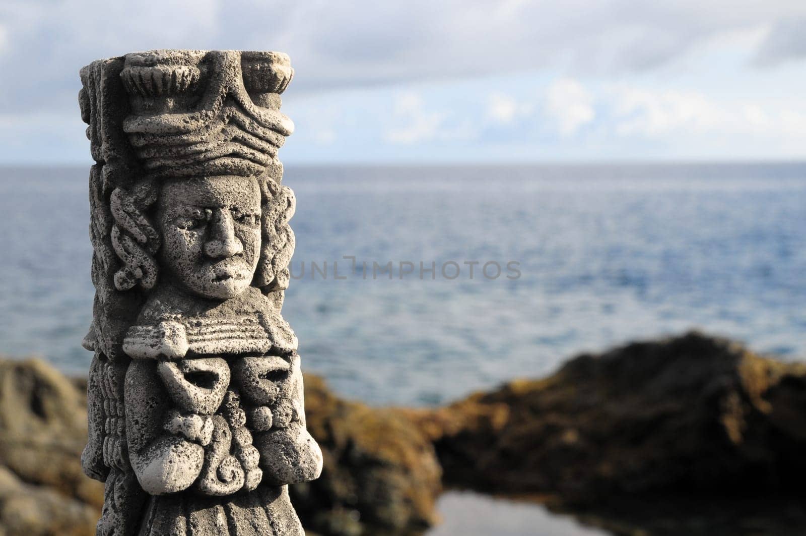 Ancient Maya Statue on the Rocks near Ocean