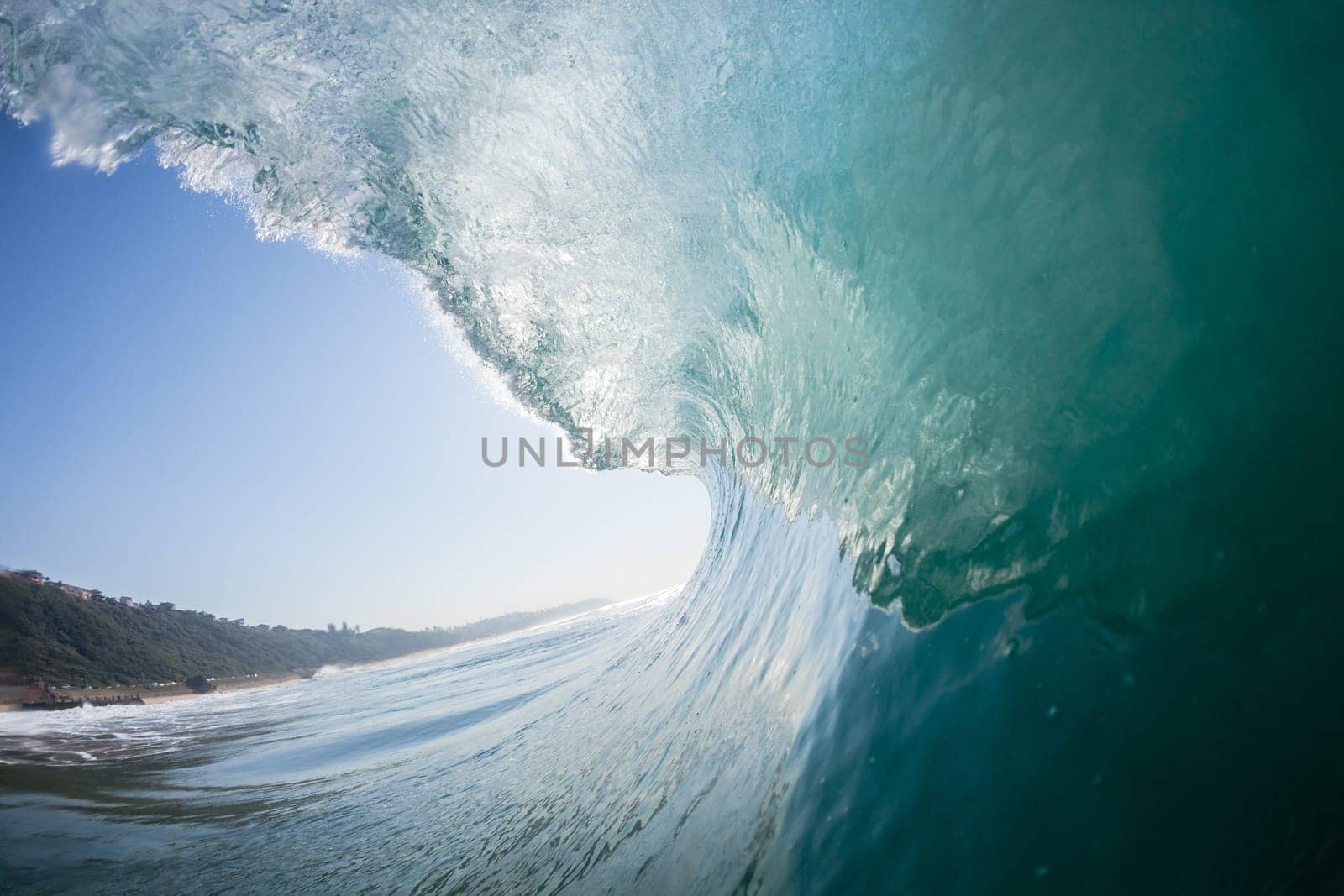 Ocean sea wave vertical crashing hollow tubing water power on shallow beach reefs sandbars, a swimming surfer action water photo