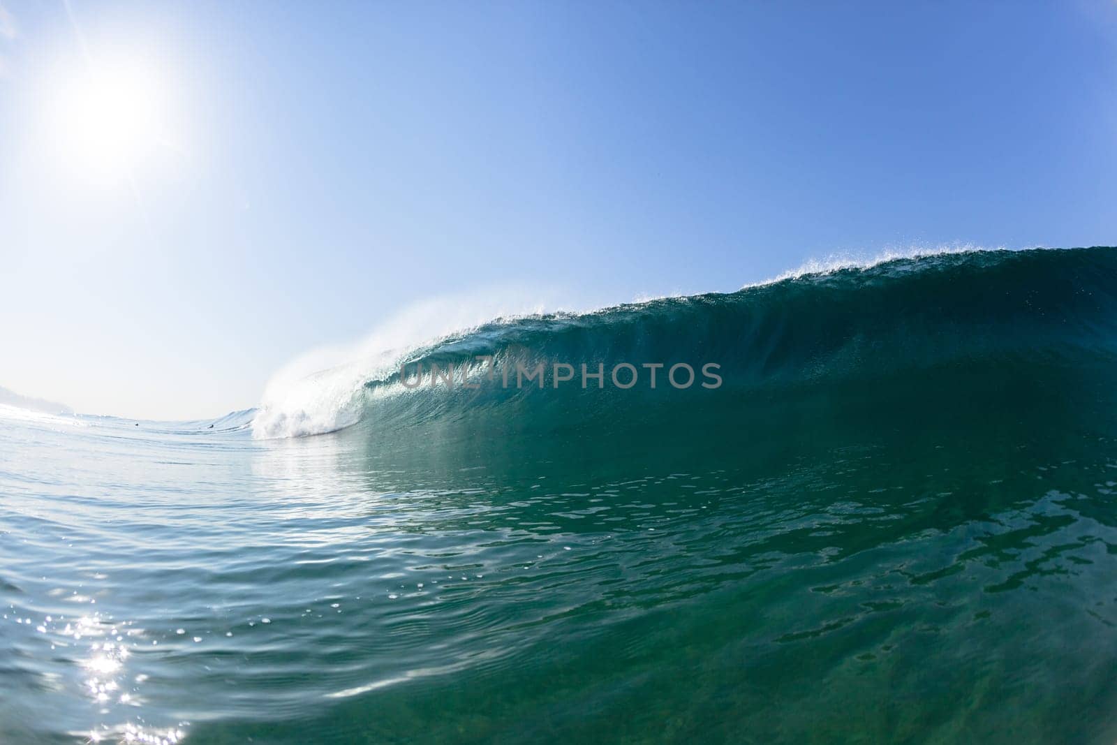 Ocean sea wave vertical crashing hollow tubing water power on shallow beach reefs sandbars, a swimming surfer action water photo
