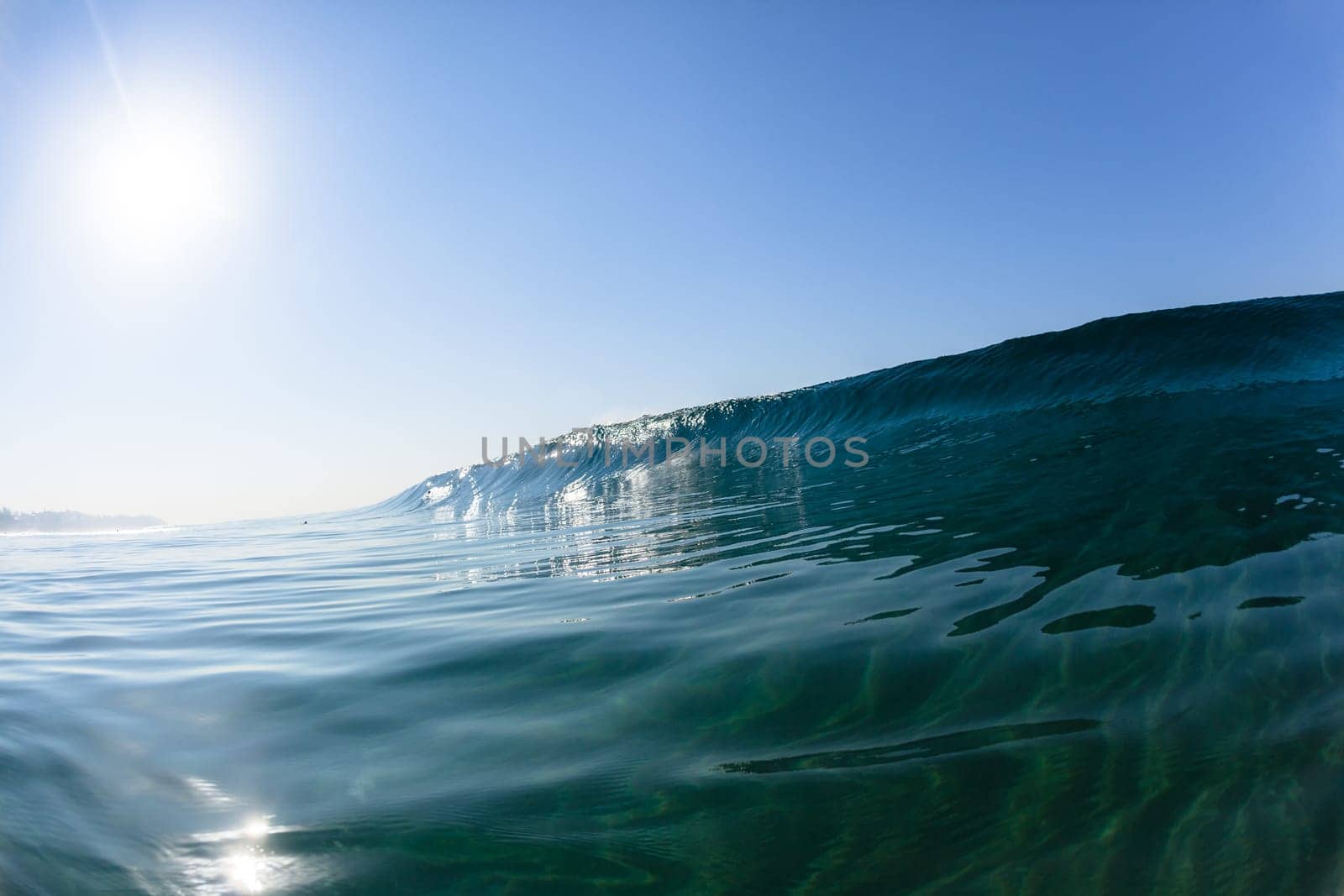 Ocean sea wave vertical crashing hollow tubing water power on shallow beach reefs sandbars, a swimming surfer action water photo
