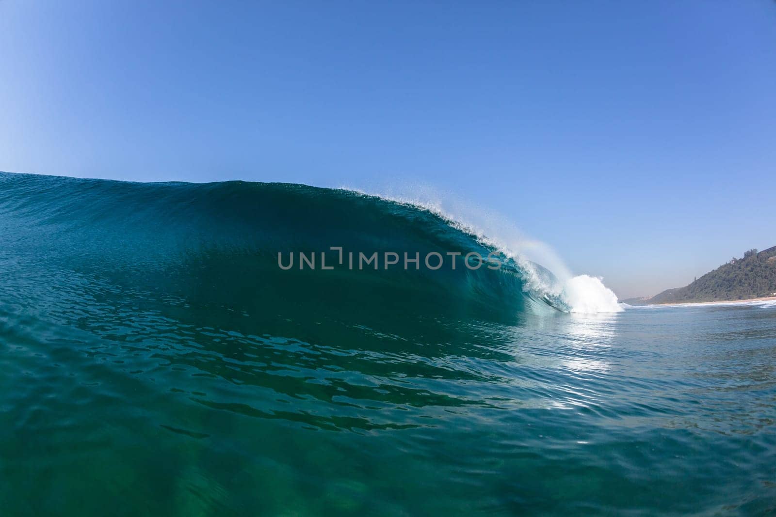 Ocean sea wave vertical crashing hollow tubing water power on shallow beach reefs sandbars, a swimming surfer action water photo