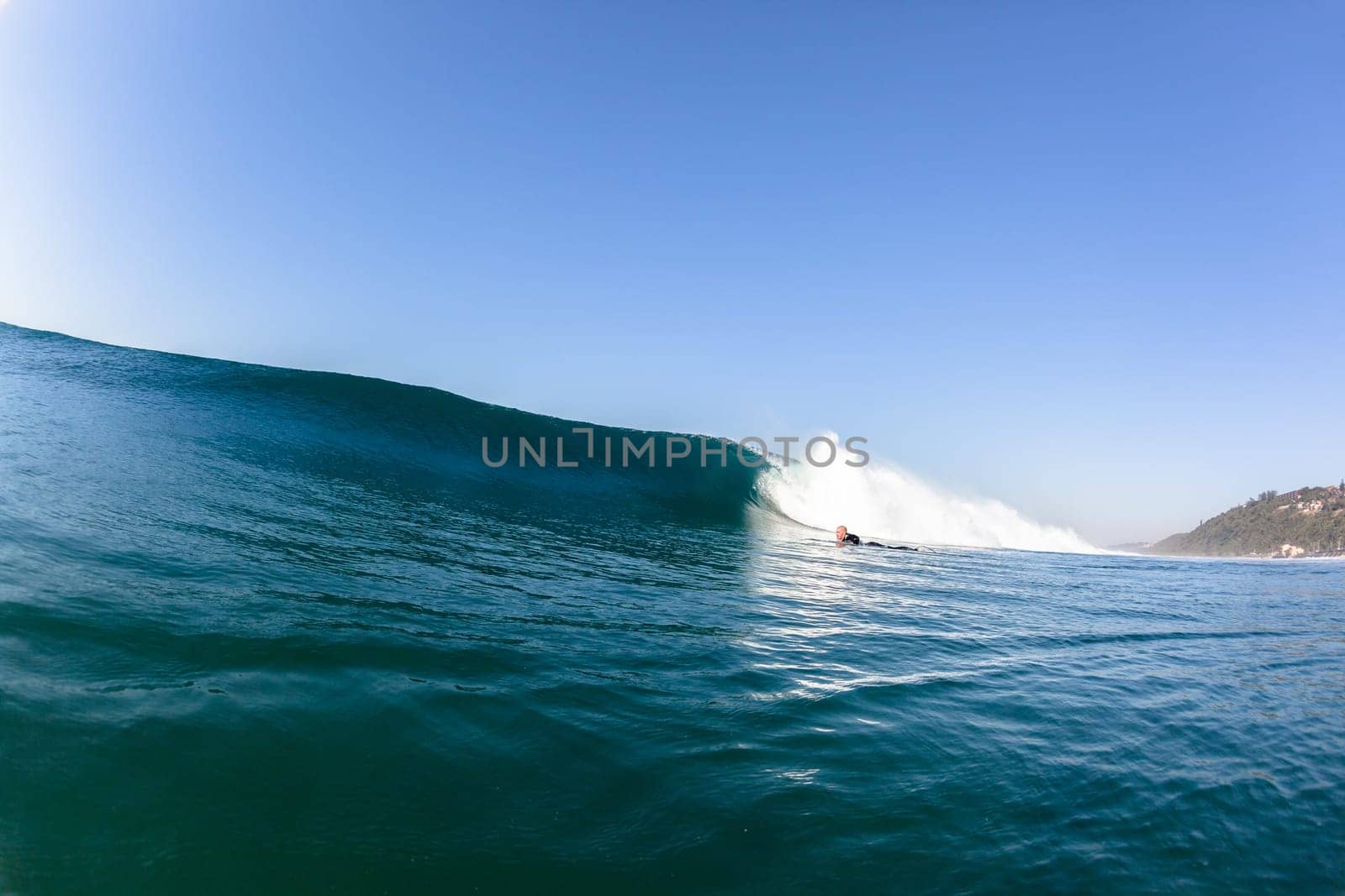 Ocean sea wave with surfer pushing under vertical crashing hollow tubing water power on shallow beach reefs sandbars, a swimming water photo