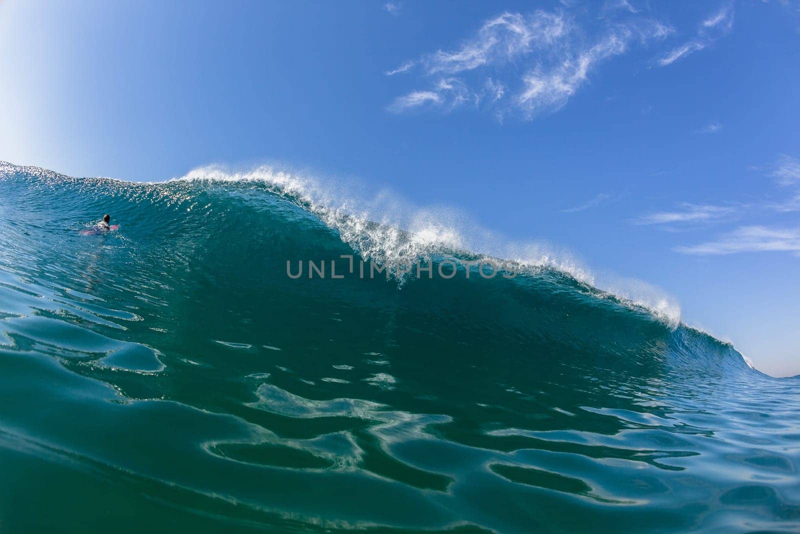 Ocean sea wave vertical crashing hollow tubing water power on shallow beach reefs sandbars, a swimming surfer action water photo