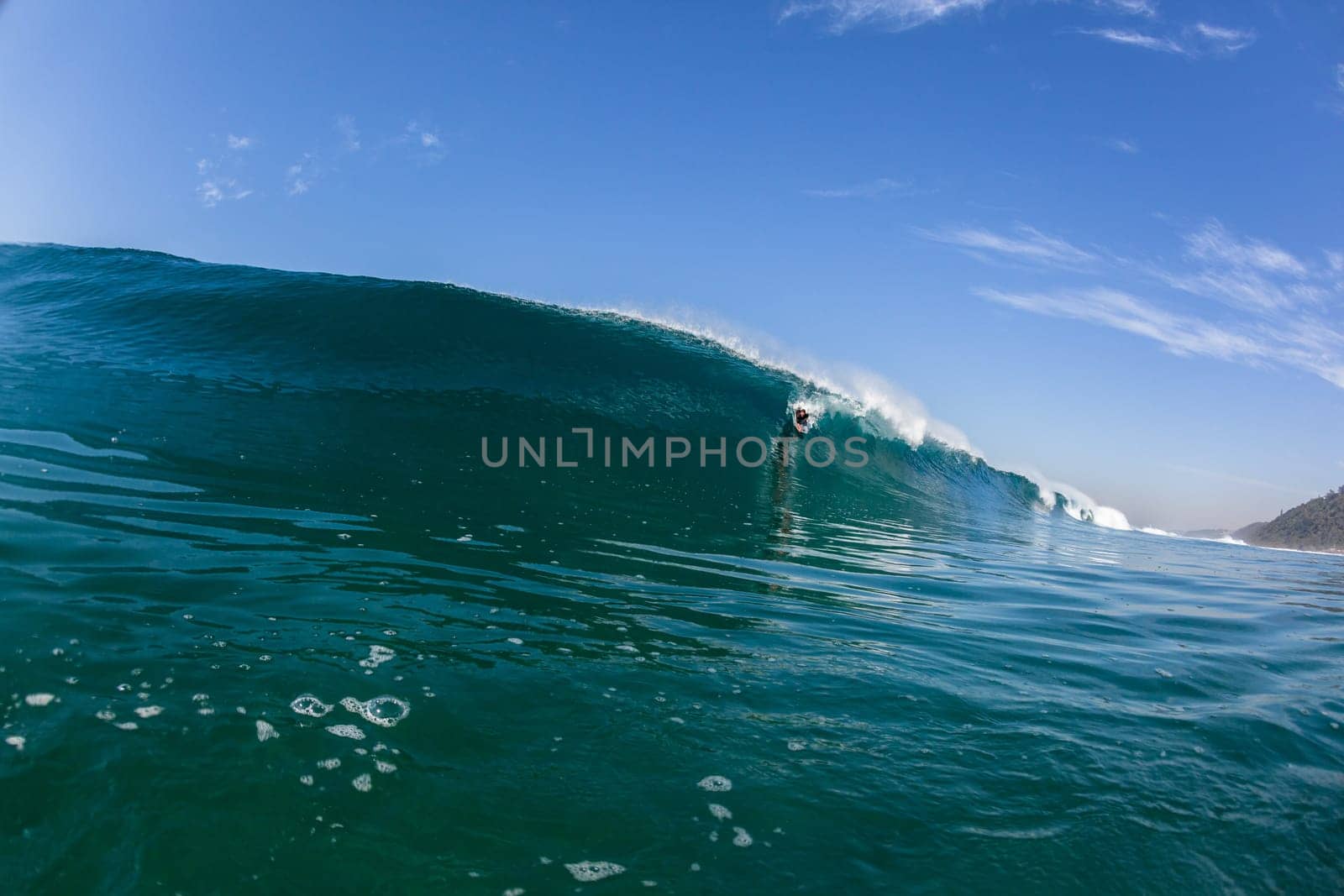 Ocean sea wave vertical crashing hollow tubing water power on shallow beach reefs sandbars, swimming water photo