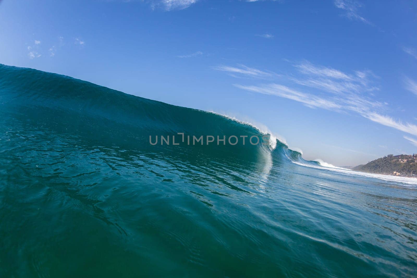 Ocean sea wave vertical crashing hollow tubing water power on shallow beach reefs sandbars, a swimming surfer action water photo