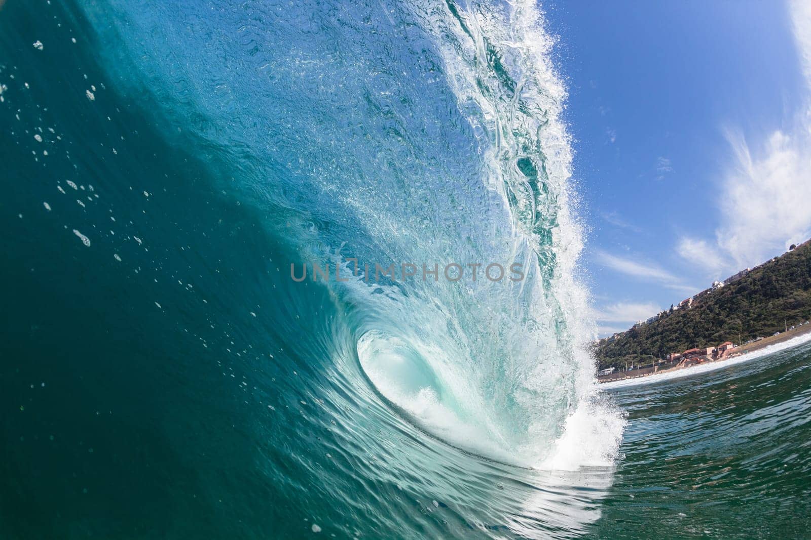 Ocean sea wave vertical crashing hollow tubing water power on shallow beach reefs sandbars, a swimming surfer action water photo