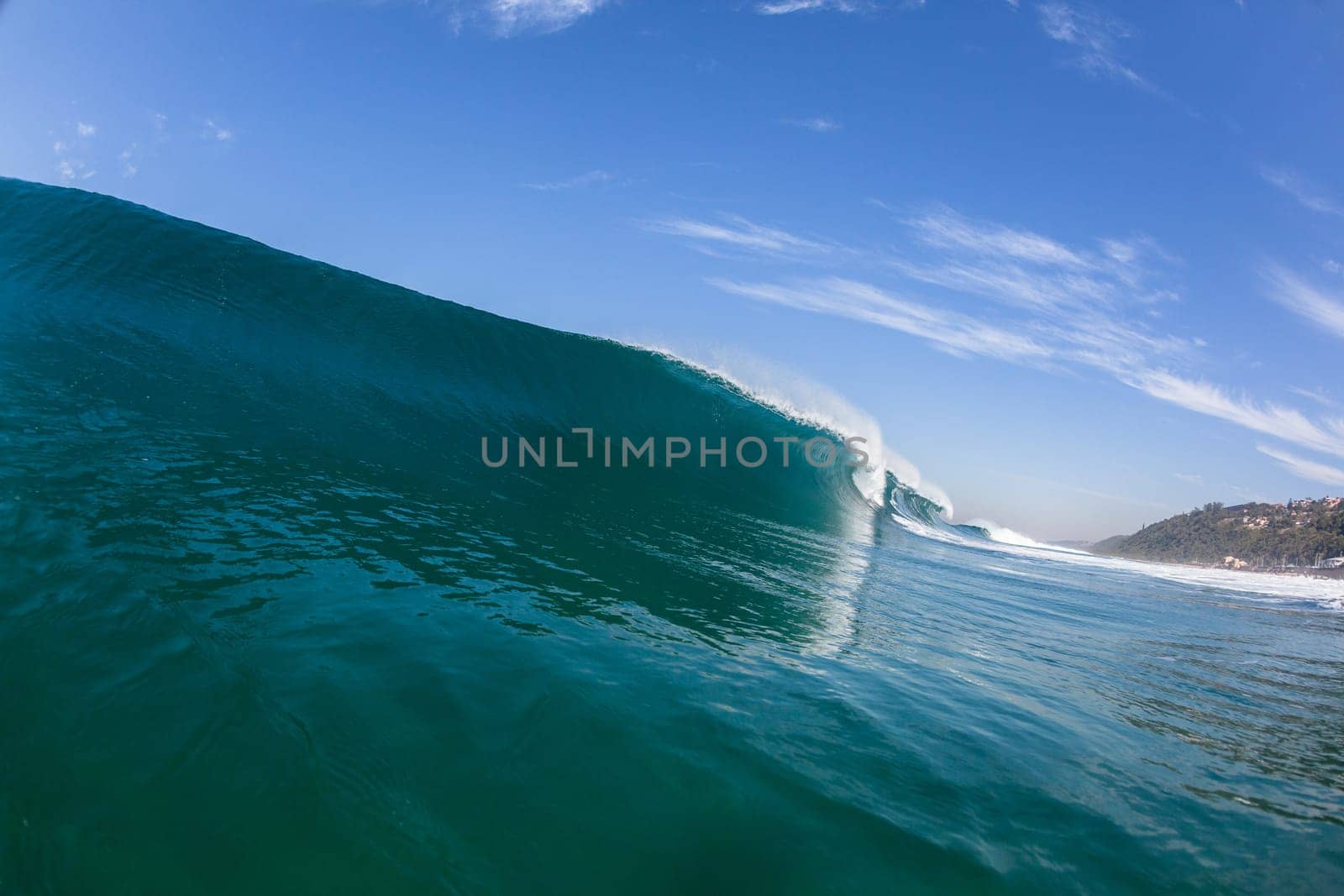 Ocean sea wave vertical crashing hollow tubing water power on shallow beach reefs sandbars, a swimming surfer action water photo