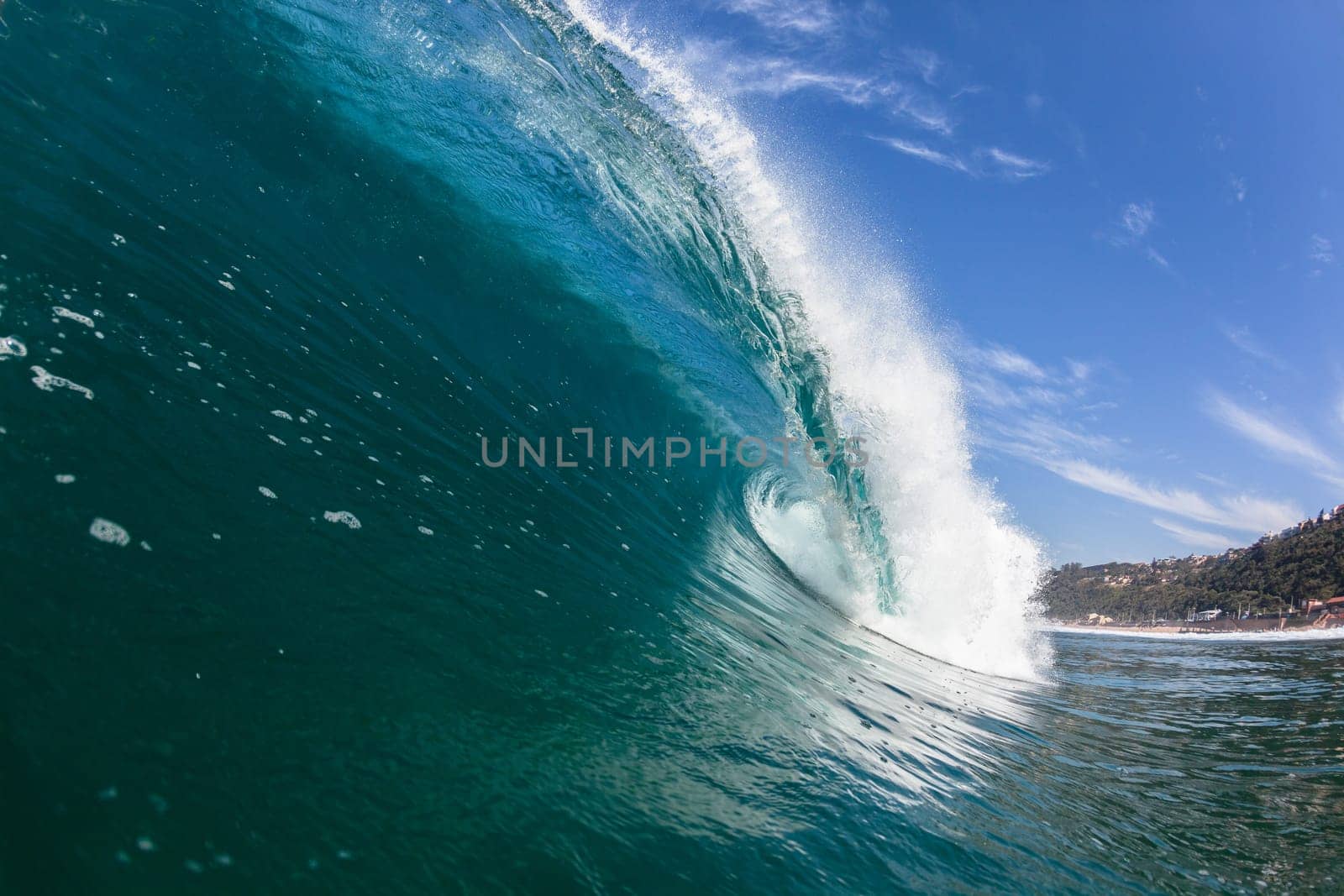 Ocean sea wave vertical crashing hollow tubing water power on shallow beach reefs sandbars, a swimming surfer action water photo
