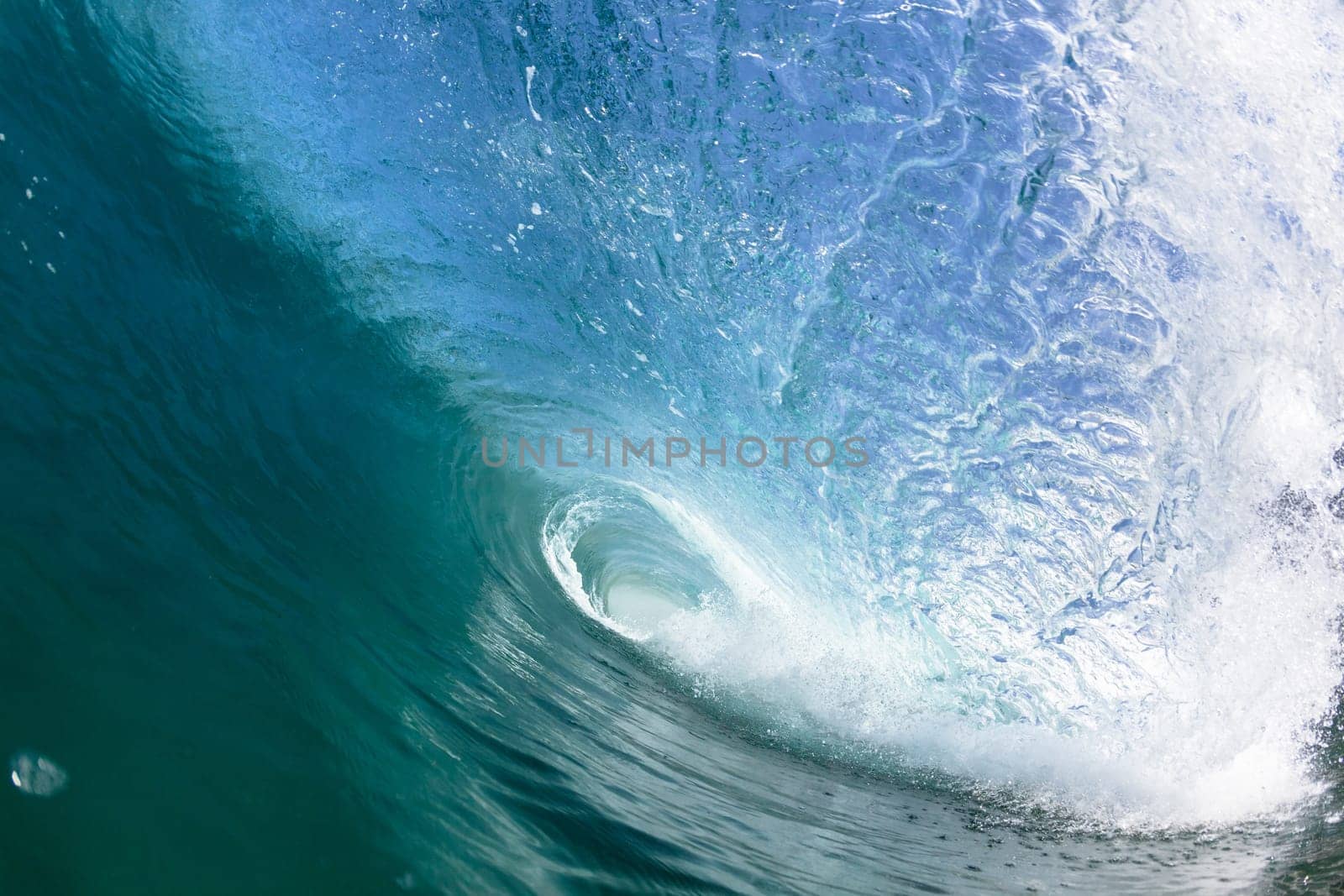 Ocean sea wave vertical crashing hollow tubing water power on shallow beach reefs sandbars, a swimming surfer action water photo