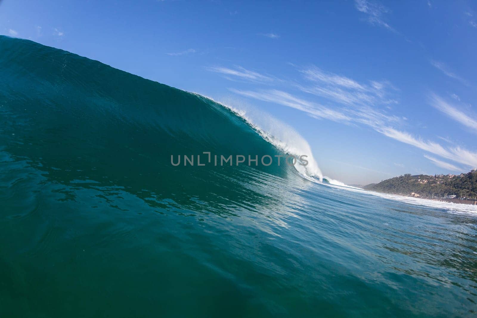 Ocean sea wave vertical crashing hollow tubing water power on shallow beach reefs sandbars, a swimming surfer action water photo