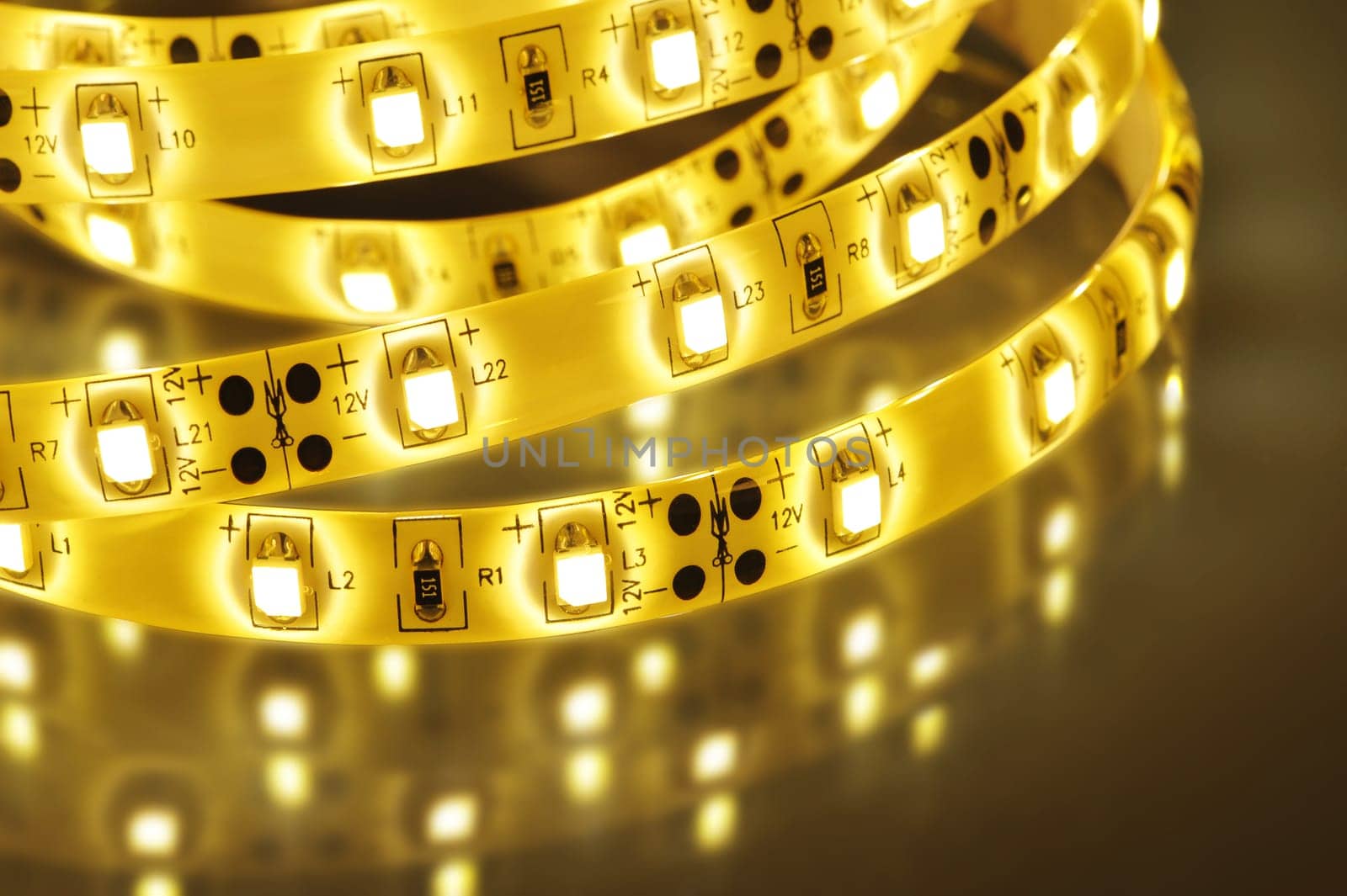 Macrodetail of a warm white LED strip in coloured light