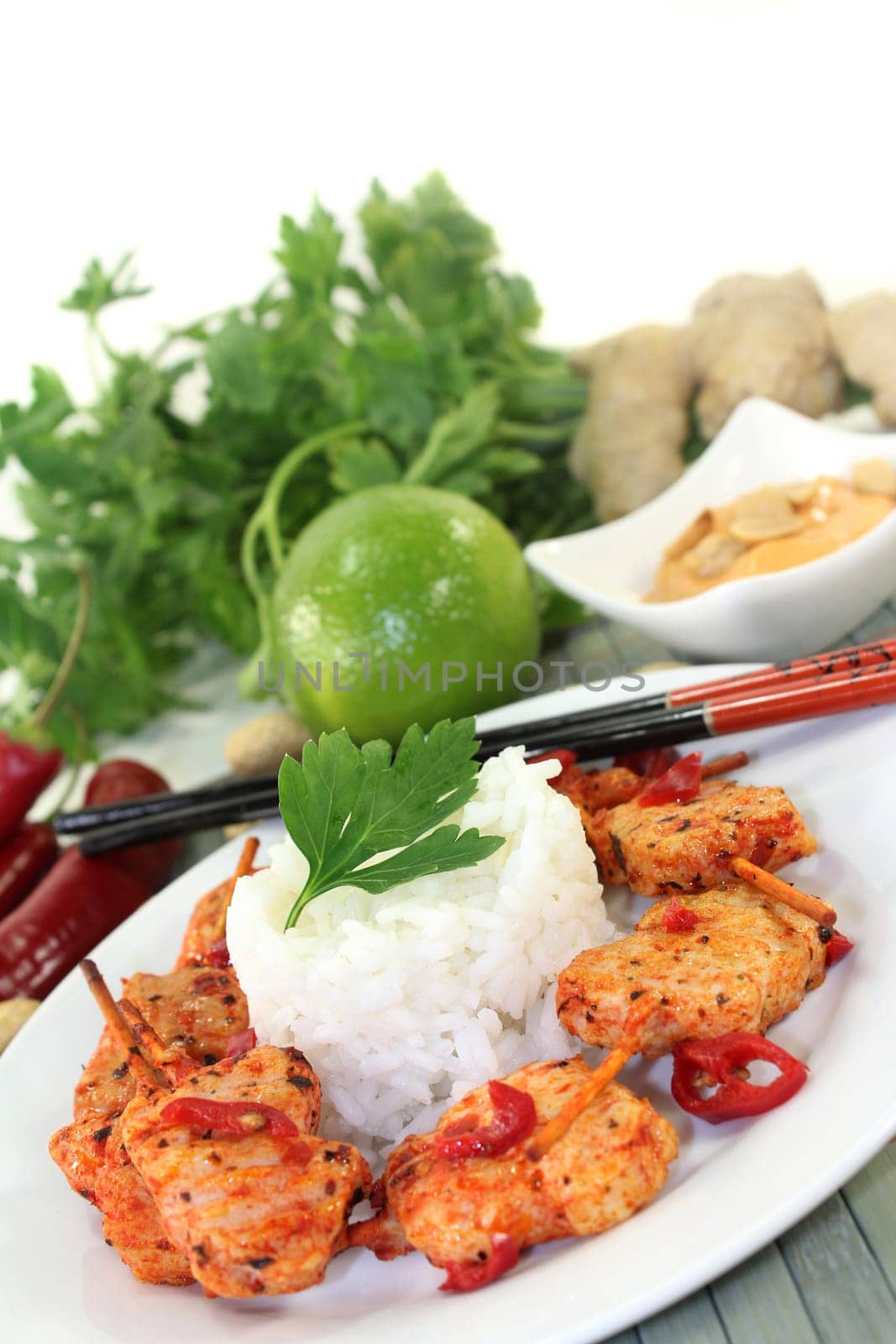Meat skewer with pepperoni on a white plate