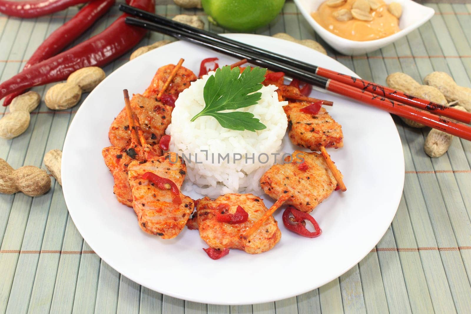 Meat skewer with pepperoni on a white plate