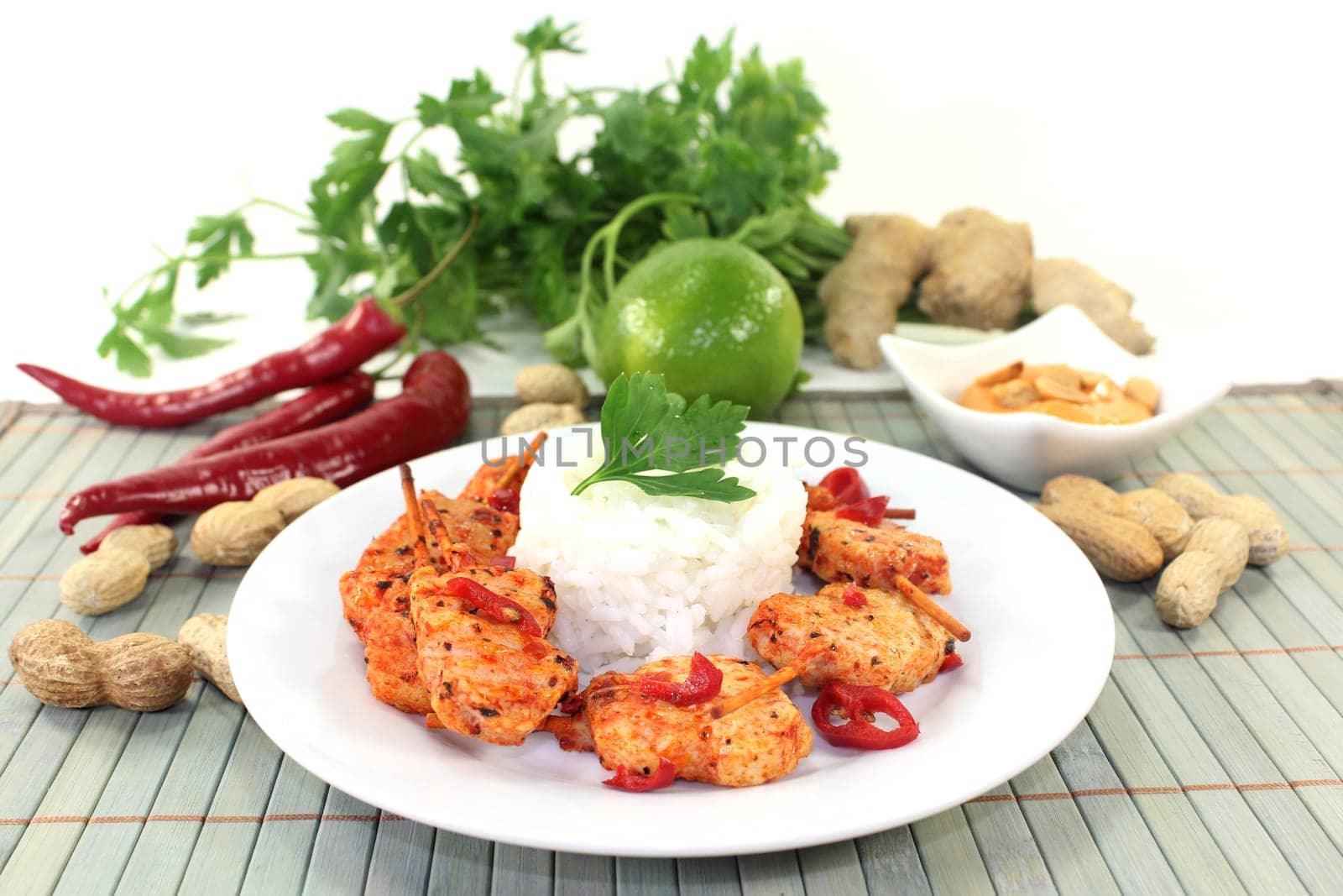 Meat skewer with pepperoni on a white plate