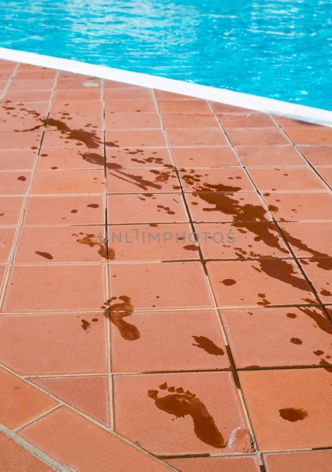 Footprints of bare feet to swimming pool. Water footprints