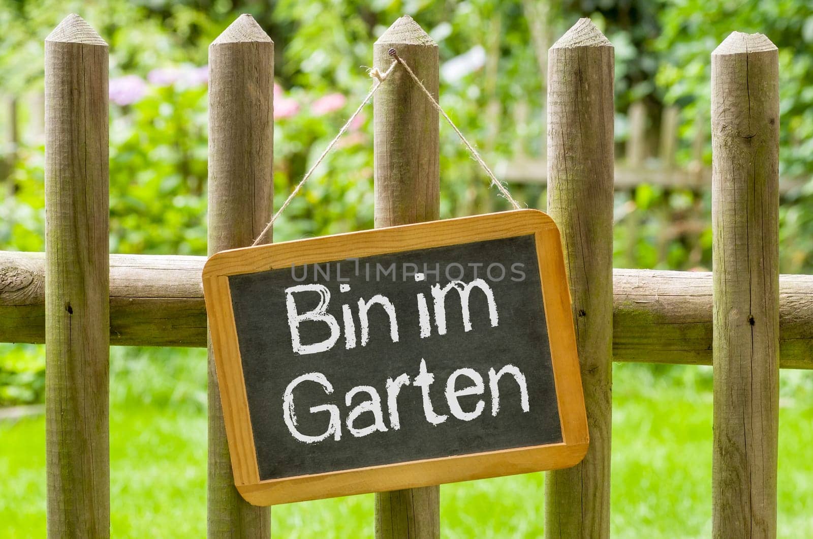 Chalkboard with the inscription Bin in the garden