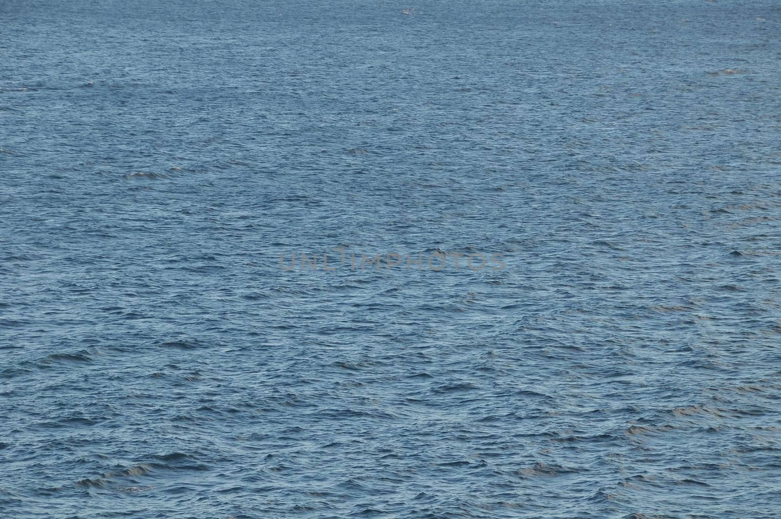 Blue Still Sea Water With Ripple. Natural Background Photo Texture