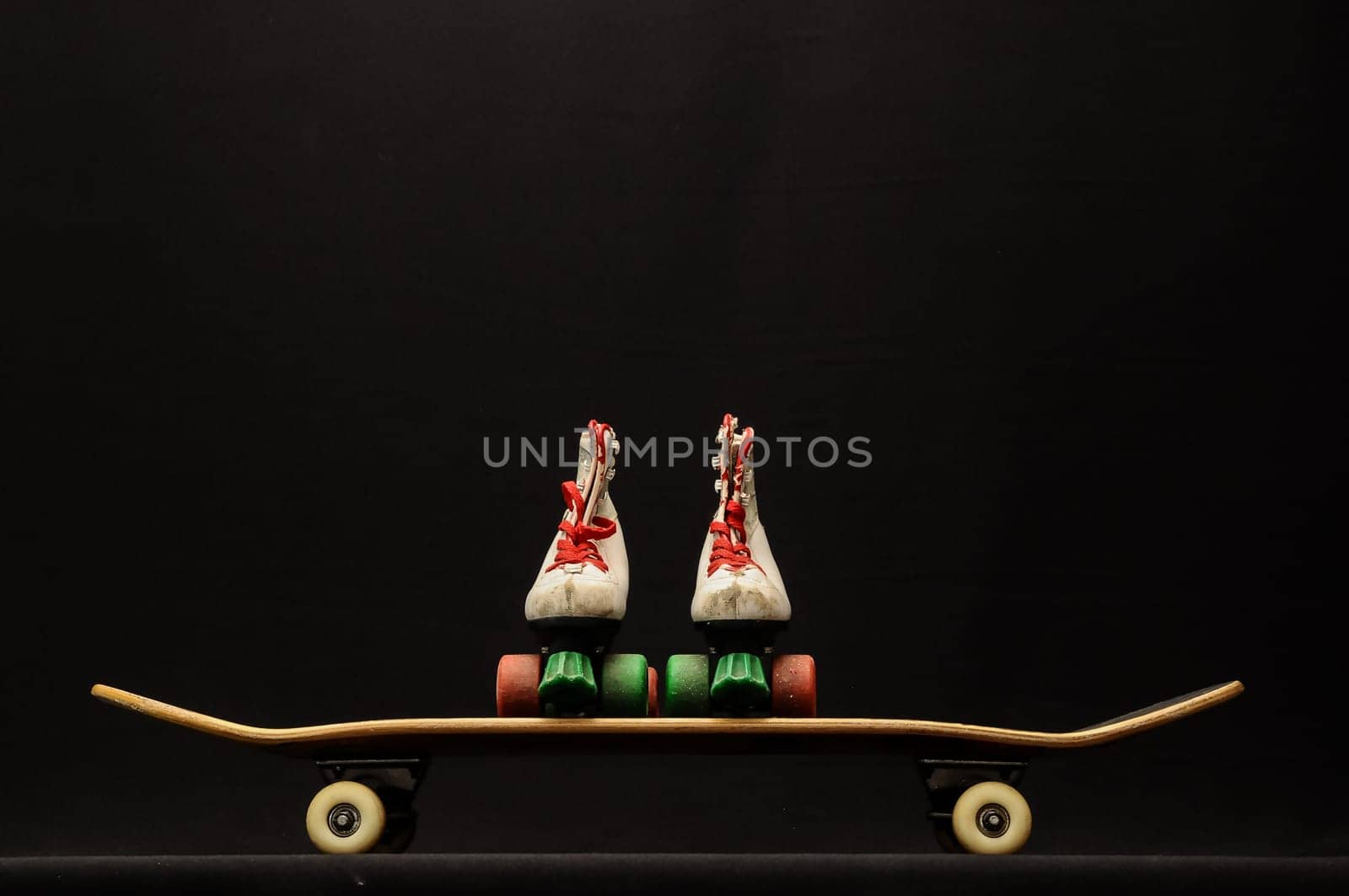 Vintage Style Black Skateboard and Skate Boot on a Dark Background
