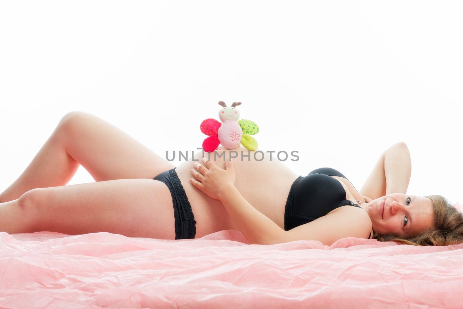Pregnant woman with cuddly toy