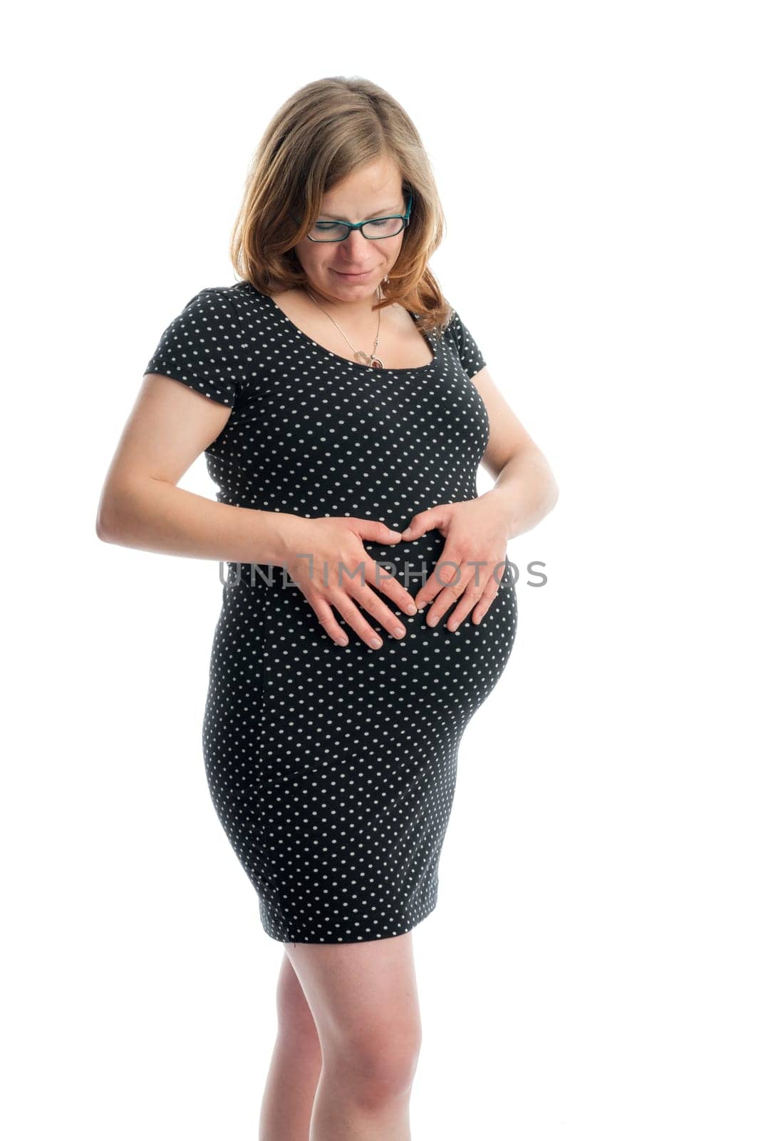Pregnant woman forms a heart