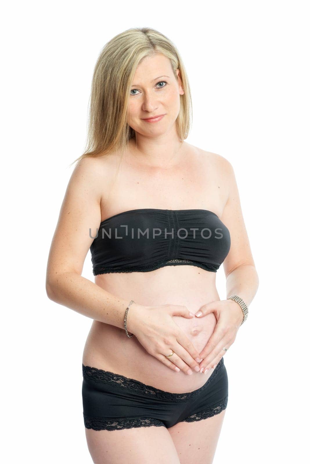 Pregnant woman forms a heart