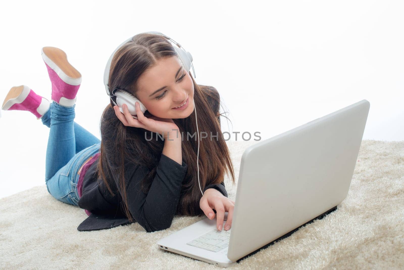 Young girl with laptop and headphones