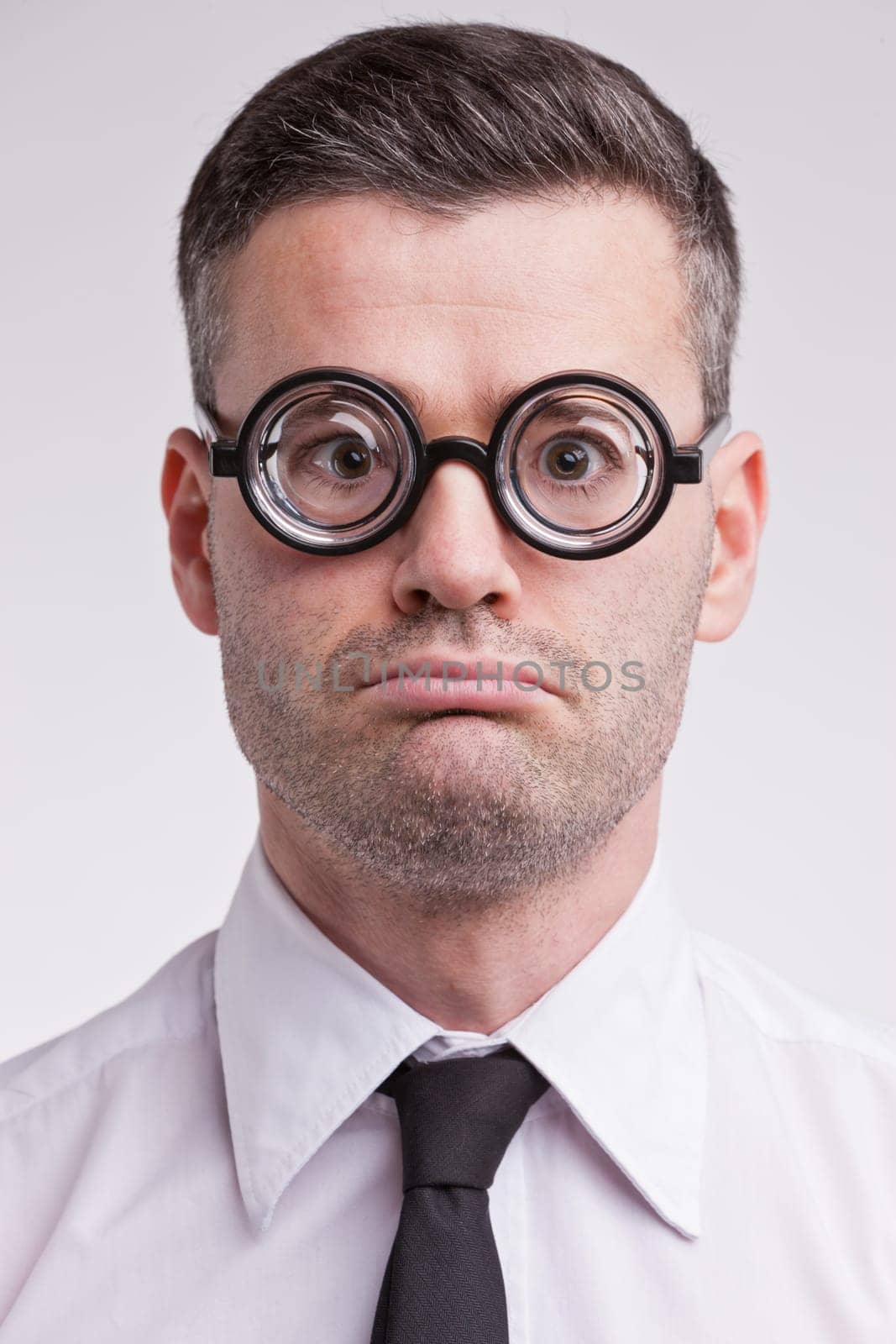 an upset and disappointed nerd clerk staring at camera very unhappy