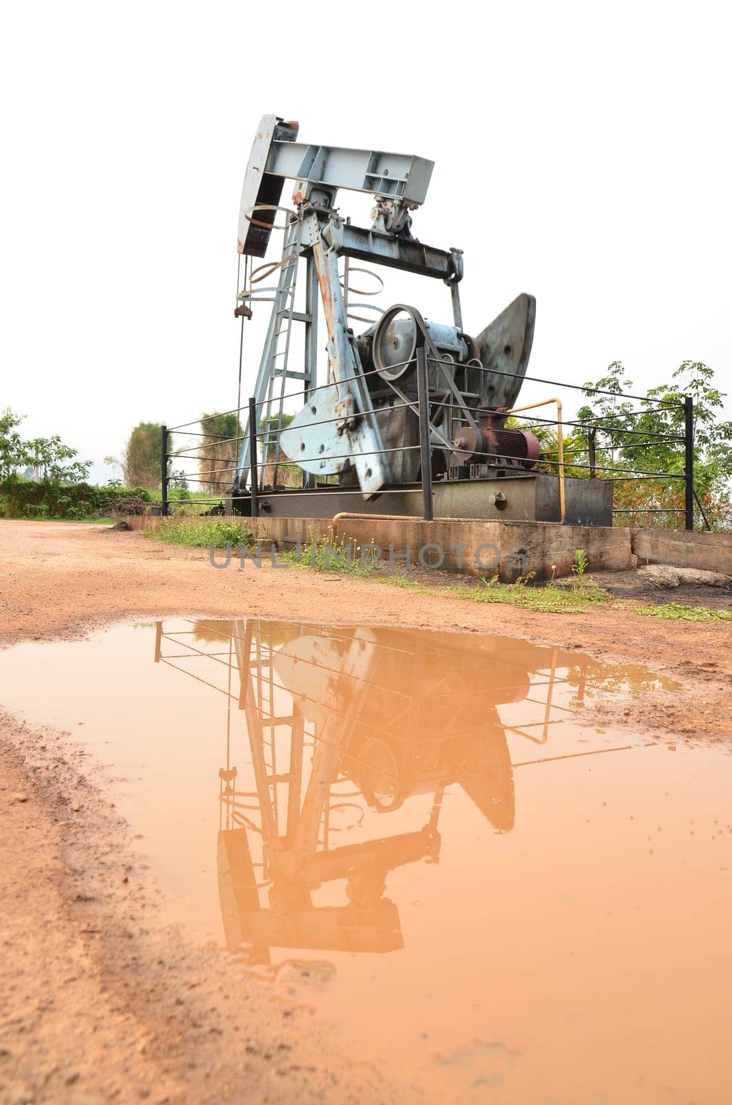 old pumpjack pumping crude oil from oil well