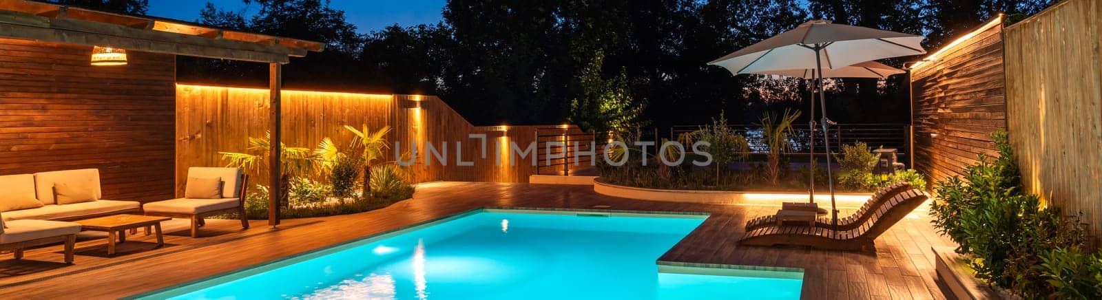 Serene backyard pool with lounge area and soft evening lighting
