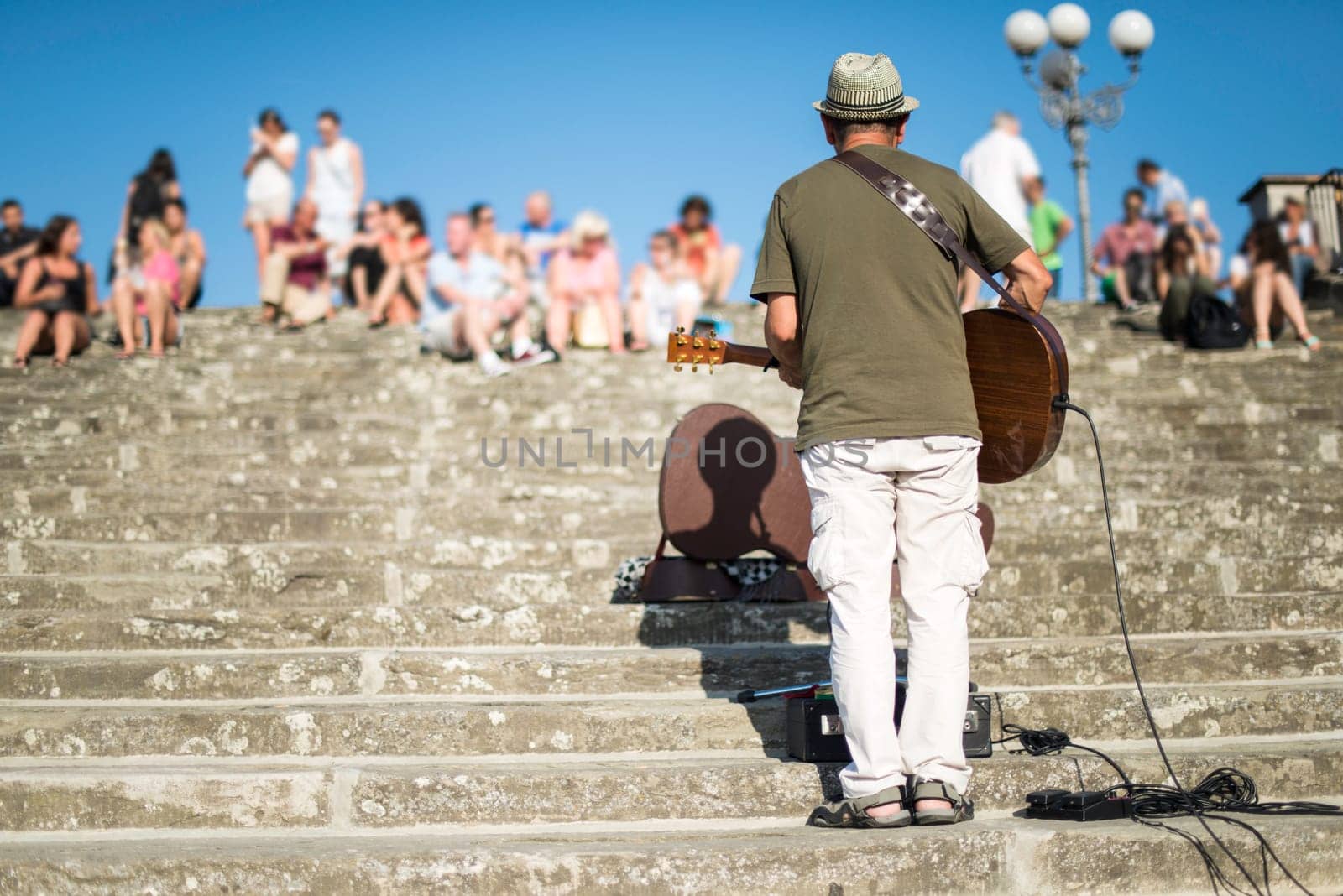Street musician singing in front of a crowd