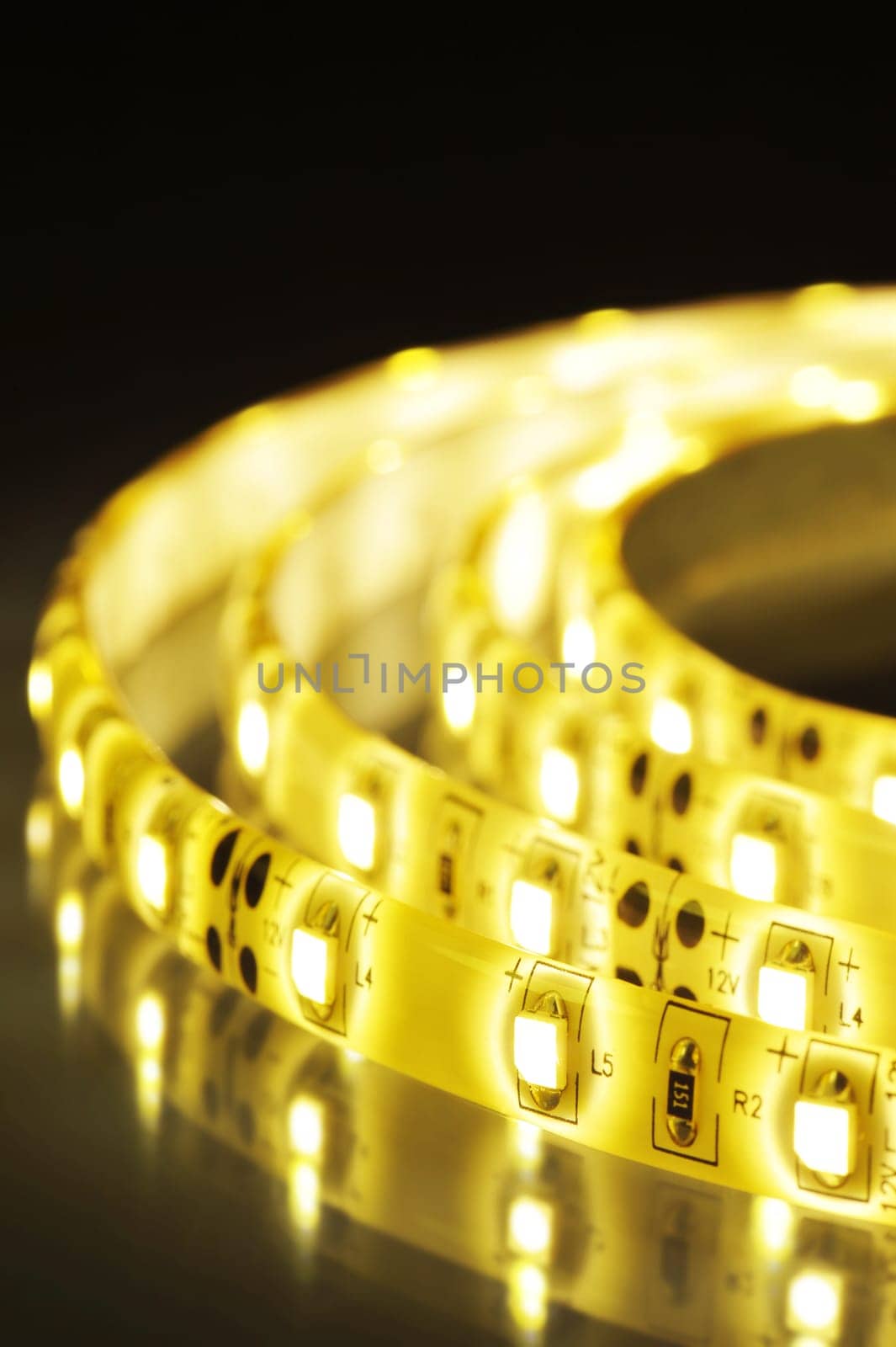 Macrodetail of a warm white LED strip in coloured light