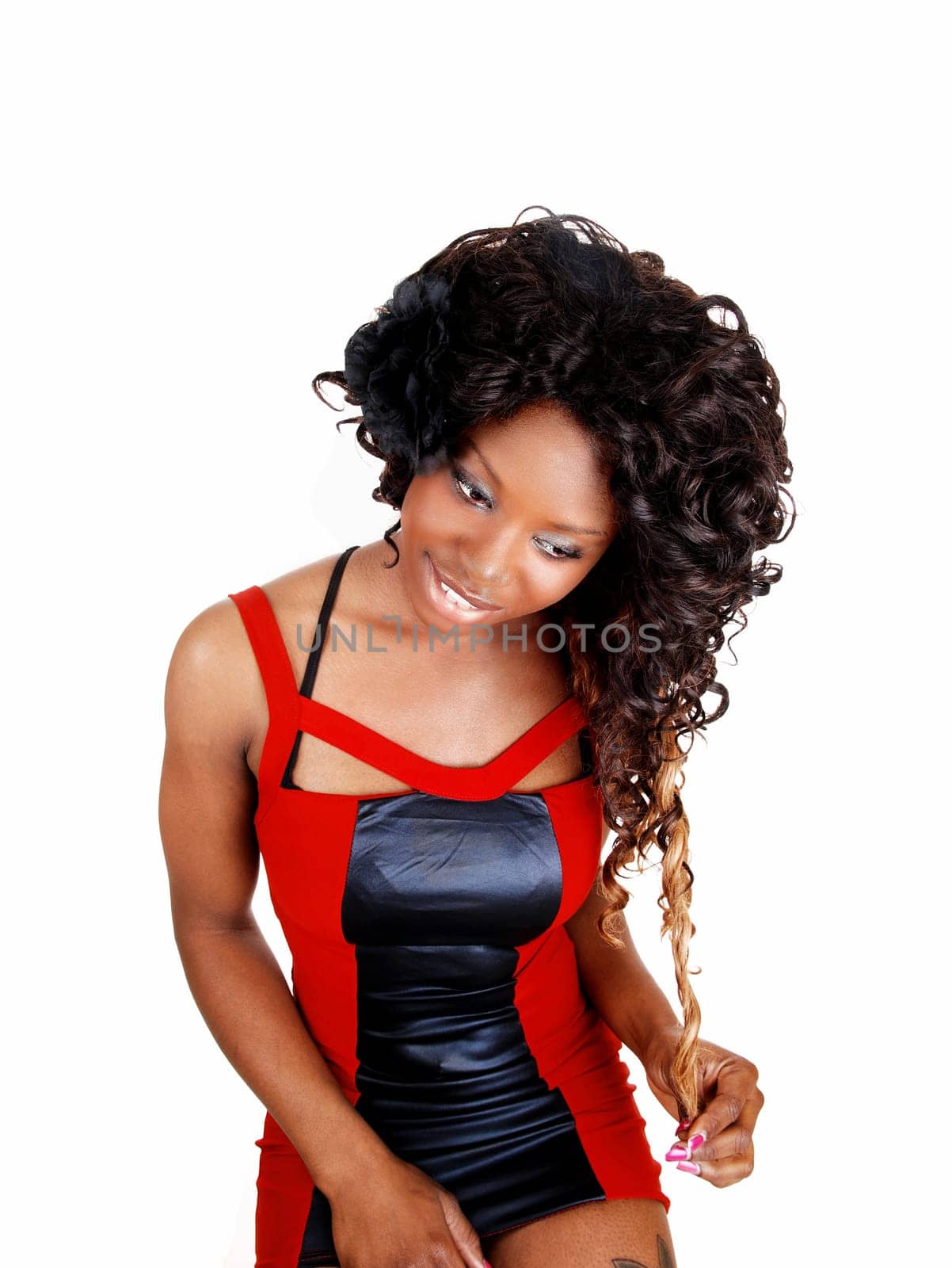 A picture of a young Jamaican woman standing and looking down,.isolated on white background..