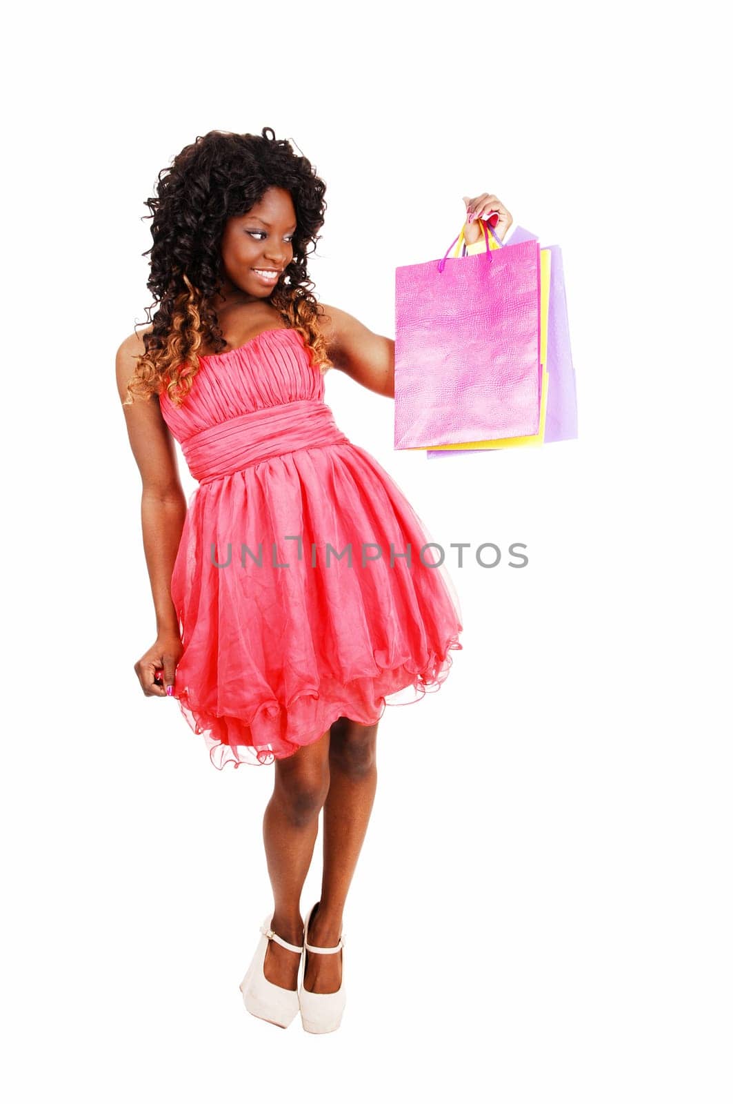 A lovely young Jamaican woman holding up some shopping bag's.isolated for white background..