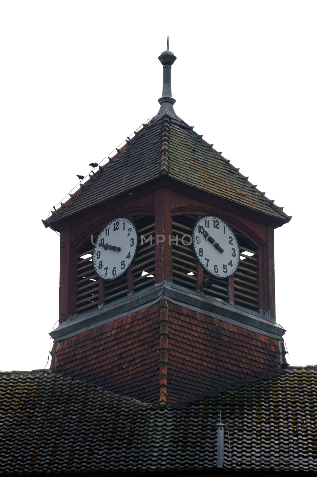 The photograph of a clock tower of a disused hospital.