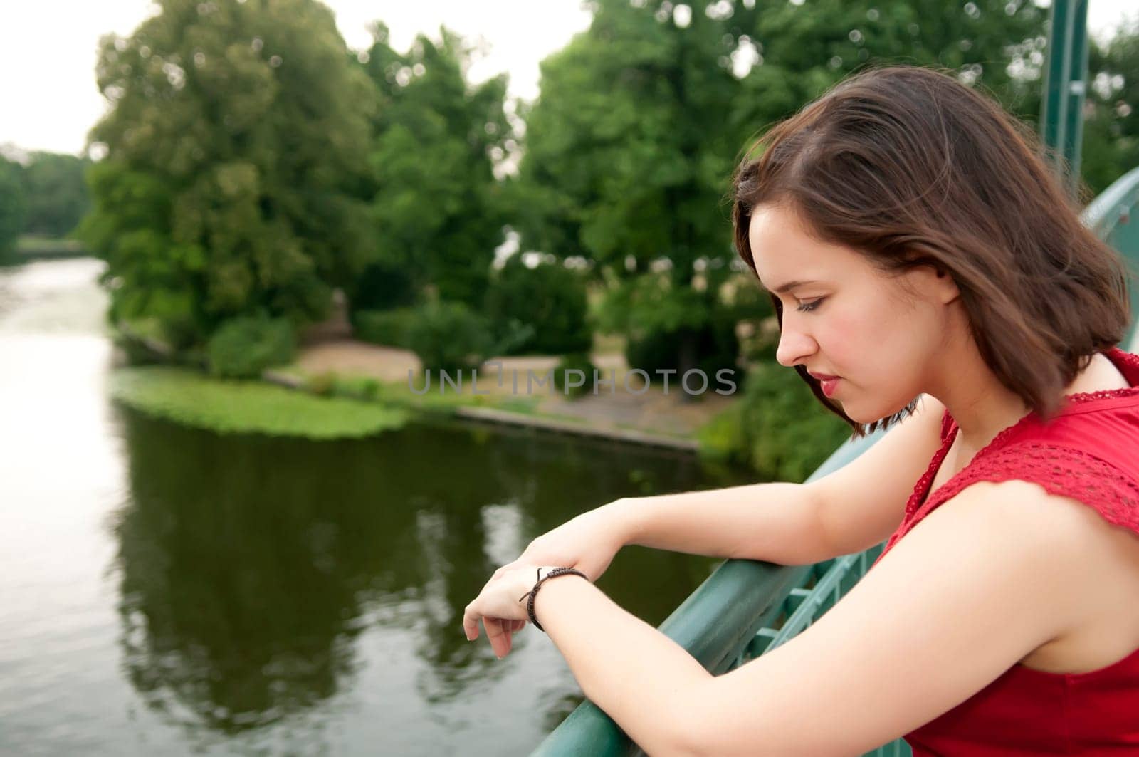 Woman stands on bridge