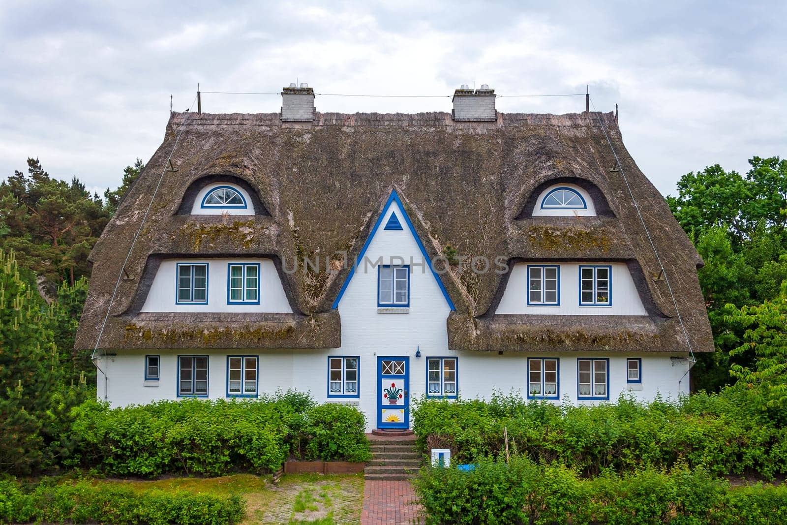 thatched-roof guesthouse with holiday apartments